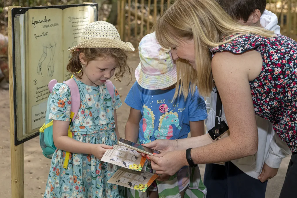 A family checking the trail guide before exploring ROARR!