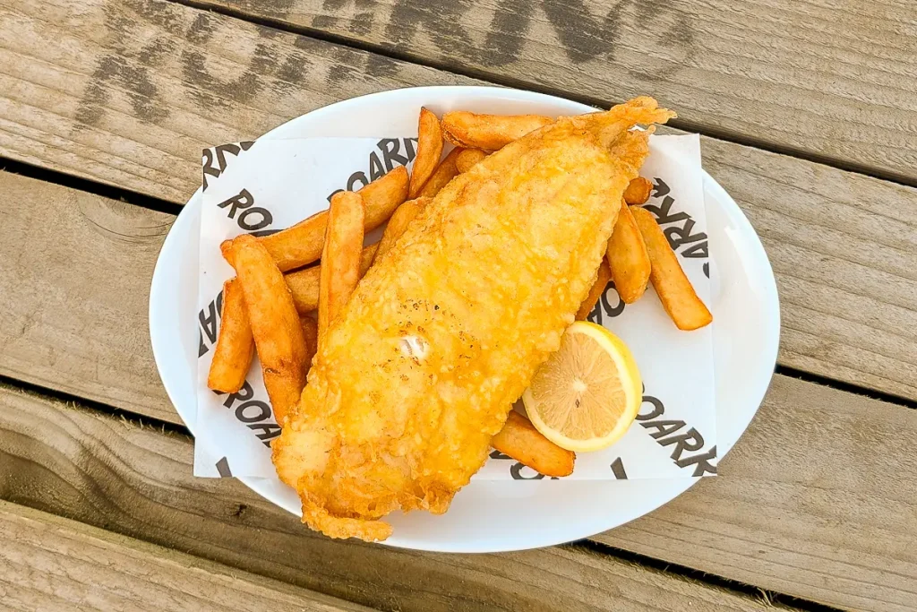 Battered fish and chunky chips on ROARR! branded paper